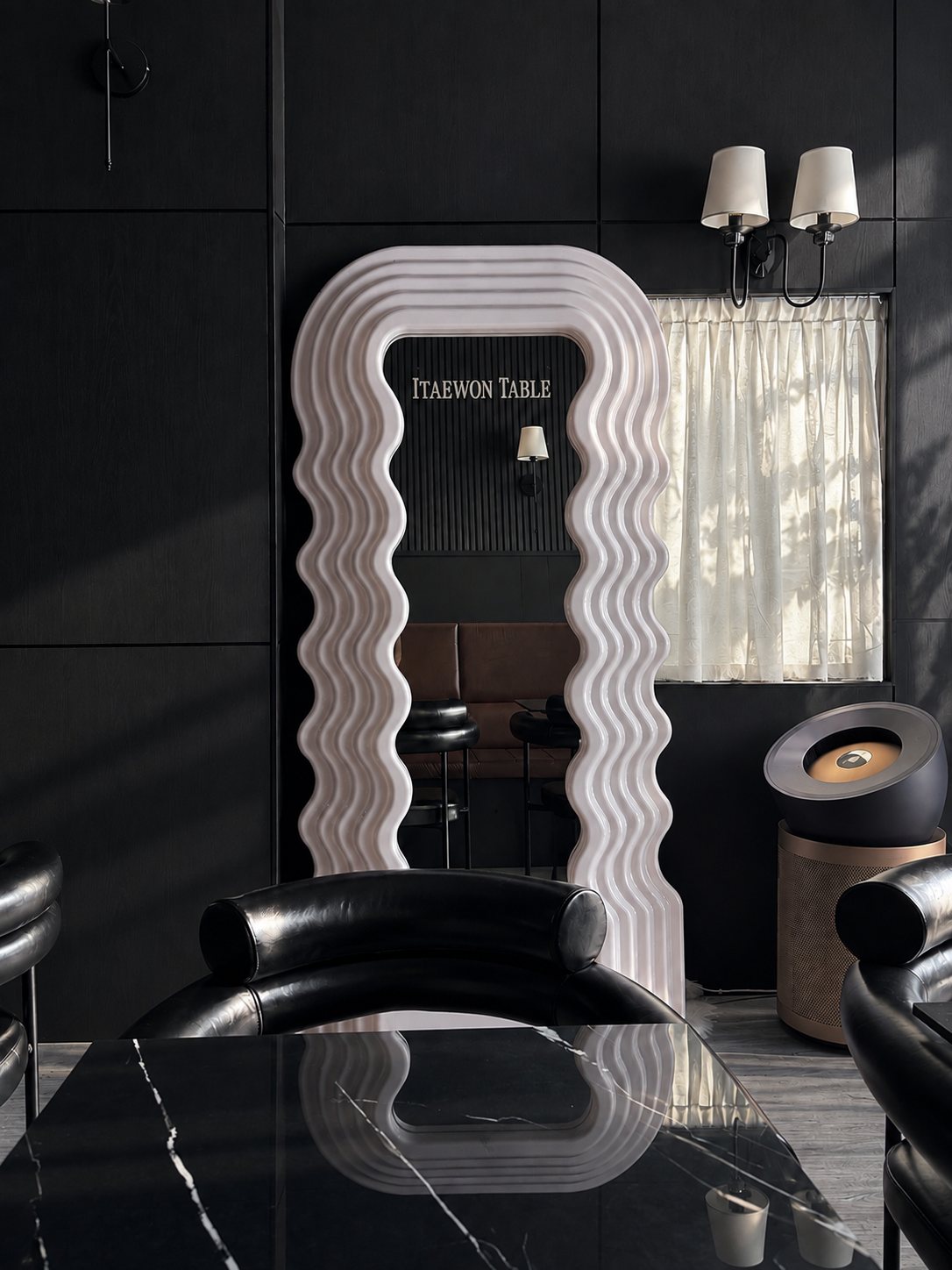 Wavy mirror with the Itaewon Table sign